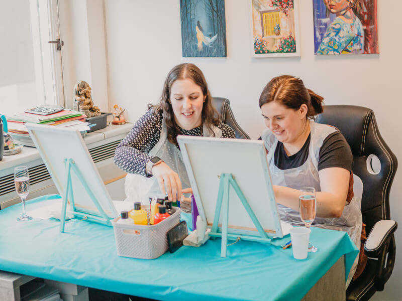 Two women learning to paint